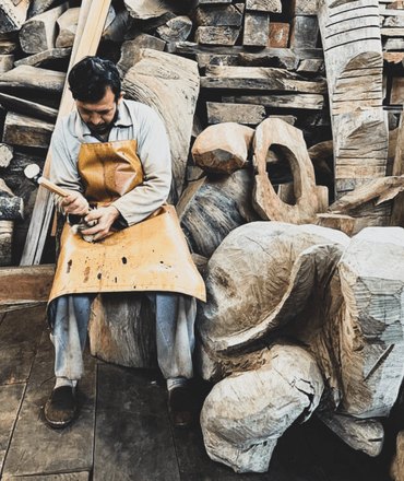 Man carving wood sculpture