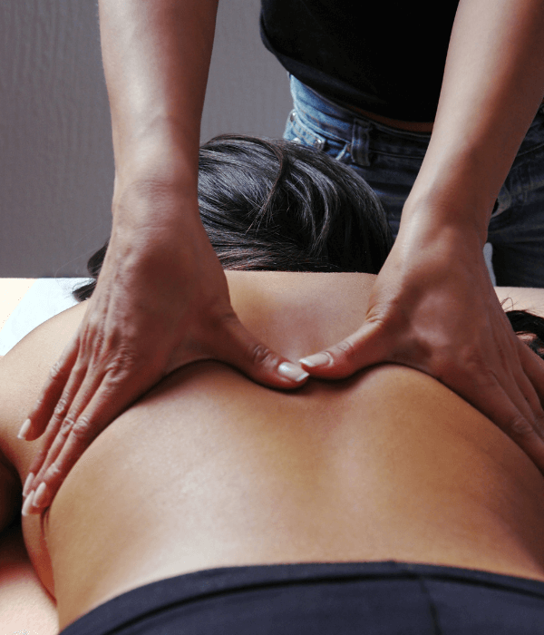 hands massaging a persons back